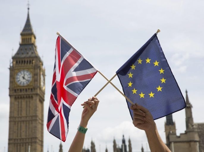 Members of the public hold flags at a stay in, pro EU Referendum event in Parliament Square, Central London, Britain, 19 June 2016. Britons will vote to stay or leave the European Union on 23 June.