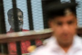 Ousted Egyptian President Mohamed Morsi looks on during a trial session on charges of espionage in Cairo, Egypt, 18 June 2016. A court sentenced ousted president Mohamed Morsi to life in prison as well as a 15-year prison sentence over charges of allegedly leaking classified documents related to national security to Qatar in exchange for payments. The court also confirmed death sentences against six co-defendants in the case.