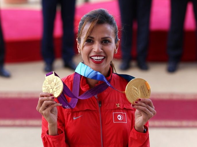 Habiba Ghribi of Tunisia poses with her gold medals for the Olympic 2012 and World 2011 3,000-metre steeplechase in Tunis, Tunisia, June 4, 2016. Ghribi received the medals on Saturday after the medals were stripped from Russia's Yuliya Zaripova due to doping. REUTERS/Zoubeir Souissi TPX IMAGES OF THE DAY