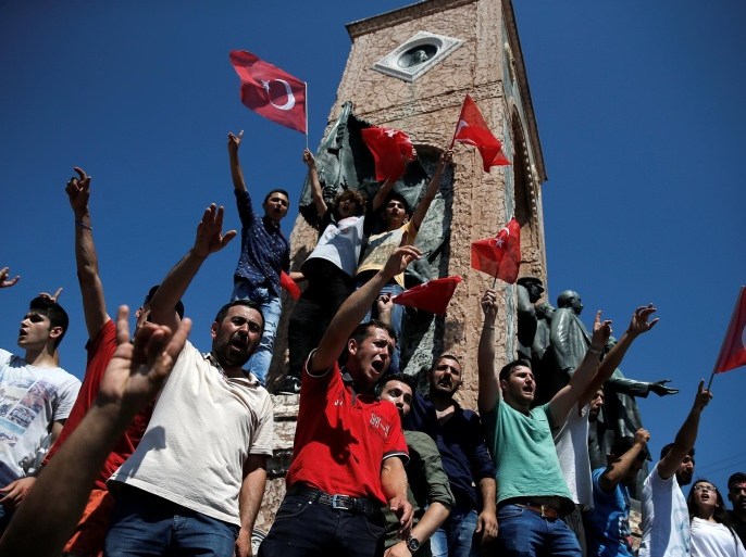 Supporters of Turkish President Tayyip Erdogan wave Turkish national flags and shout slogans as they stand around the Republic Monument in Taksim Square in Istanbul, Turkey, July 16, 2016. REUTERS/Alkis Konstantinidis