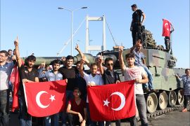 epa05427483 Turkish police and supporters of President Recep Tayyip Erdogan display the Turkish national flag as they cheer next to a tank on the Bosphorus Bridge after a failed coup attempt, in Istanbul, Turkey, 16 July 2016. Turkish Prime Minister Yildirim reportedly said that the Turkish military was involved in an attempted coup d'etat. The Turkish military meanwhile stated it had taken over control. According to news reports, Turkish President Recep Tayyip Erdogan has denounced the coup attempt as an 'act of treason' and insisted his government remains in charge. Some 104 coup plotters were killed, 90 people - 41 of them police and 47 are civilians - 'fell martrys', after an attempt to bring down the Turkish government, the acting army chief General Umit Dundar said in a televised appearance. EPA/STR