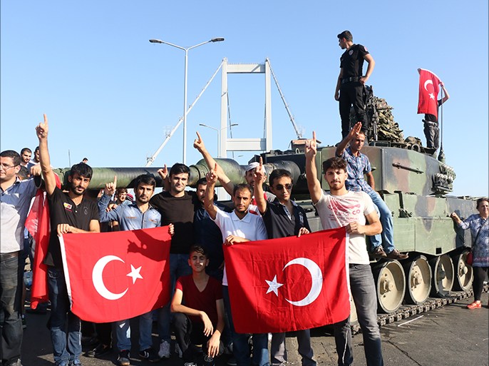 epa05427483 Turkish police and supporters of President Recep Tayyip Erdogan display the Turkish national flag as they cheer next to a tank on the Bosphorus Bridge after a failed coup attempt, in Istanbul, Turkey, 16 July 2016. Turkish Prime Minister Yildirim reportedly said that the Turkish military was involved in an attempted coup d'etat. The Turkish military meanwhile stated it had taken over control. According to news reports, Turkish President Recep Tayyip Erdogan has denounced the coup attempt as an 'act of treason' and insisted his government remains in charge. Some 104 coup plotters were killed, 90 people - 41 of them police and 47 are civilians - 'fell martrys', after an attempt to bring down the Turkish government, the acting army chief General Umit Dundar said in a televised appearance. EPA/STR