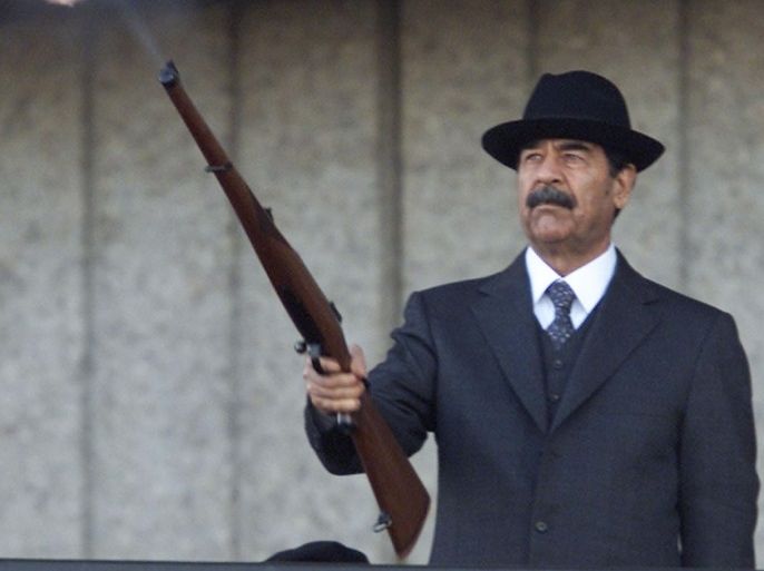 Iraqi President Saddam Hussein fires shots into the air during a military parade in Baghdad, Iraq December 31, 2000. Picture taken Deember 31, 2000. REUTERS/Faleh Kheiber/File Photo