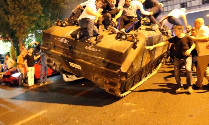 People occupy a tank in Istanbul, Turkey, 16 July 2016. Turkish Prime Minister Yildirim reportedly said that the Turkish military was involved in an attempted coup d'etat. The Turkish military meanwhile stated it had taken over control.