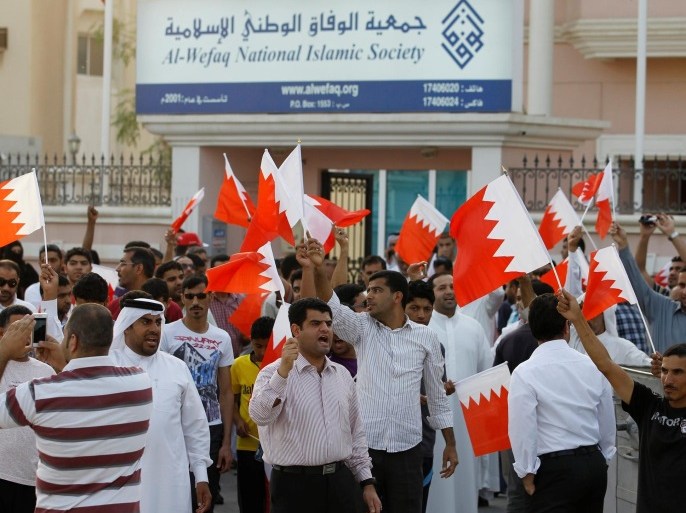 Anti-government protesters shout slogans while holding Bahraini flags during a protest outside Bahrain's leading opposition party Al Wefaq's headquarters in Manama in this file photo taken on May 9, 2012. A Bahraini court ordered the suspension of the main opposition group al-Wefaq and closed down its offices on June 14, 2016. REUTERS/Hamad I Mohammed