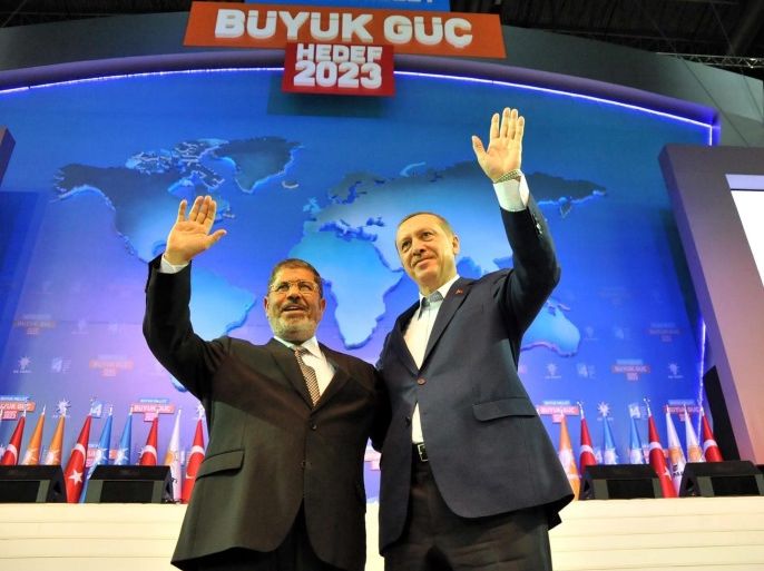 A handout photo released by the Egyptian Presidency shows Egyptian President Mohamed Morsi (L) and Turkey's Prime Minister and leader of the ruling Justice and Development Party (AKP) Recep Tayyip Erdogan (R) during the AKP party's congress in Ankara, Turkey, 30 September 2012. Morsi arrived in Turkey for few hours visit that will focus on boosting bilateral ties. Morsi met with Turkish President Abdullah Gul and delivered a speech at the AKP party's congress. EPA/EGYPTIAN PRESIDENCY/HANDOUT *** Local Caption *** 50426962