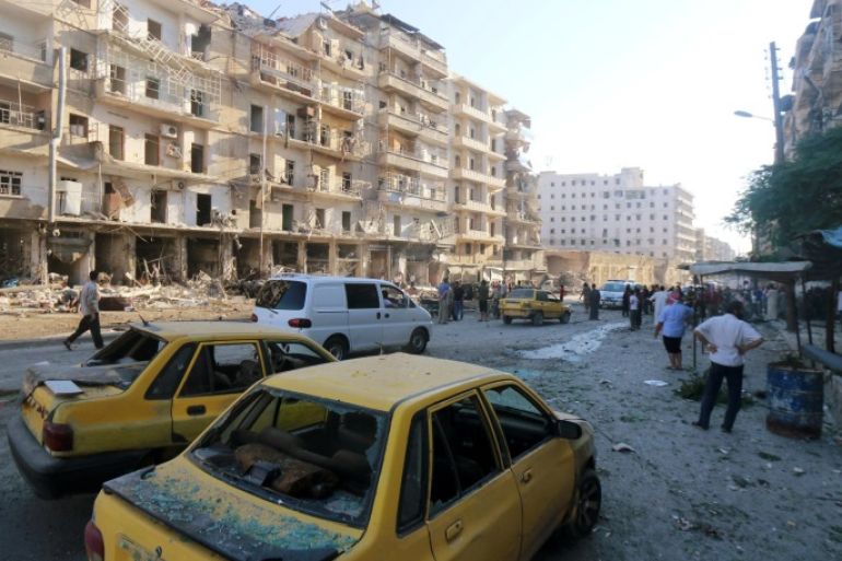 Damaged vehicles are pictured as people inspect a site hit by an airstrike in the rebel held area of Tariq al-Bab district of Aleppo, Syria, July 1, 2016. REUTERS/Abdalrhman Ismail