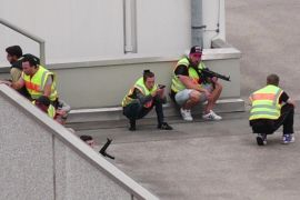 A screen grab taken from video footage shows plain clothes police officers taking cover in the car park of the Olympia shopping mall during shooting rampage in Munich, Germany July 22, 2016. dedinac/Marc Mueller/handout via REUTERS NO ARCHIVES. FOR EDITORIAL USE ONLY. NOT FOR SALE FOR MARKETING OR ADVERTISING CAMPAIGNS. THIS IMAGE HAS BEEN SUPPLIED BY A THIRD PARTY. IT IS DISTRIBUTED, EXACTLY AS RECEIVED BY REUTERS, AS A SERVICE TO CLIENTS. TPX IMAGES OF THE DAY