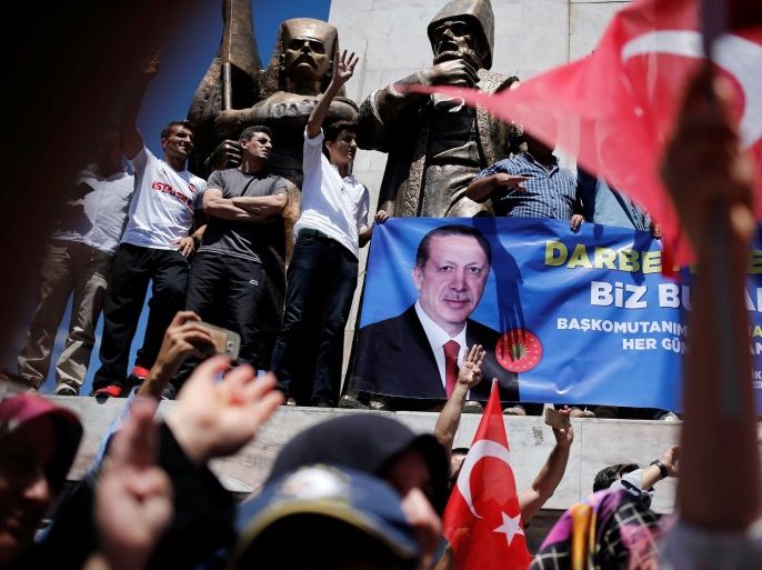 Supporters hold a banner with a photo of Turkish President Tayyip Erdogan during a pro-government demonstration in Sarachane park in Istanbul, Turkey, July 19, 2016. REUTERS/Alkis Konstantinidis
