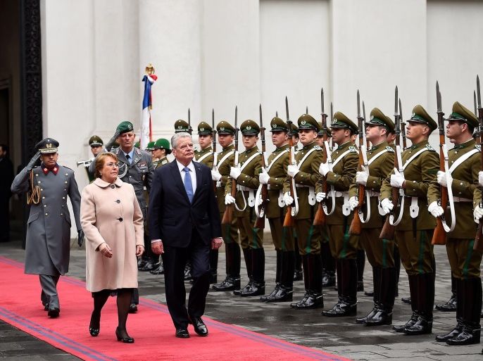 Chile's President Michelle Bachelet and German President Joachim Gauck walk past a honor guard inside the government house in Santiago, Chile July 12, 2016. Sebastian Rodriguez/Courtesy of Chilean Presidency/Handout via Reuters ATTENTION EDITORS - THIS IMAGE WAS PROVIDED BY A THIRD PARTY. EDITORIAL USE ONLY.