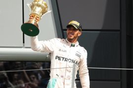 Britain Formula One - F1 - British Grand Prix 2016 - Silverstone, England - 10/7/16 Mercedes' Lewis Hamilton celebrates on the podium with the trophy after winning the race REUTERS/Andrew Boyers Livepic EDITORIAL USE ONLY.