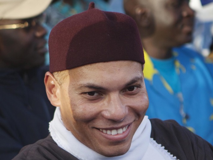 karim wade (c), son of senegal's former president abdoulaye wade, attends a rally of his father's political party parti democratique senegalais (pds) in dakar, in this file picture taken december 6, 2012. reuters/joe penney/files