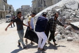 ATTENTION EDITORS - VISUAL COVERAGE OF SCENES OF INJURY OR DEATH Men carry a dead body near a damaged building after an airstrike on the rebel held Al-Hilwaniyeh neighbourhood in Aleppo, Syria July 14, 2016. REUTERS/Abdalrhman Ismail