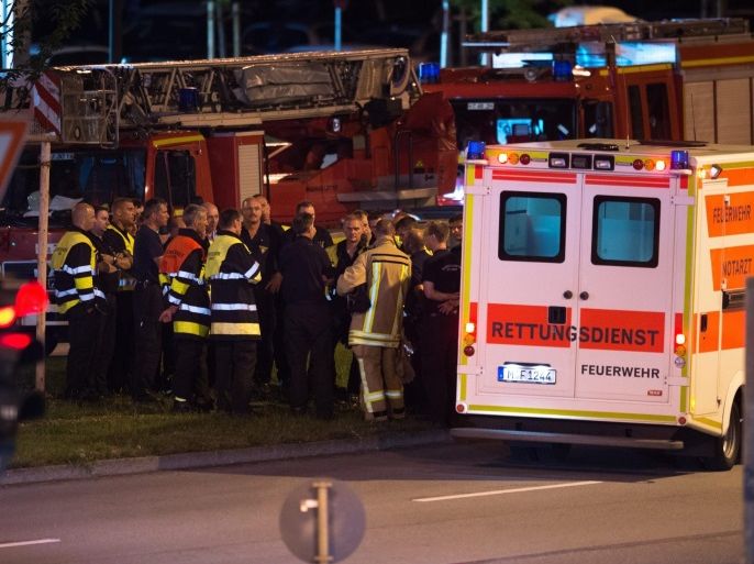 Emergency personnel gather close to the Olympia shopping centre (OEZ) where a shooting was reported, Munich, Germany, 22 July 2016. After a shooting at the Olympia shopping centre during Friday evening, the police reports at least 9 dead and 10 injured.
