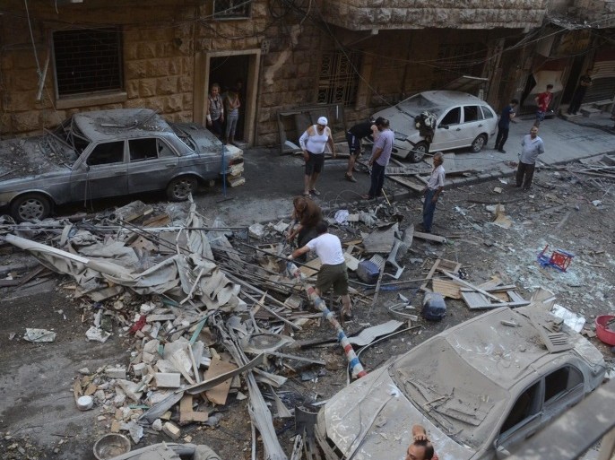 A handout photograph released by the official Syrian Arab News Agency (SANA) shows people inspecting a residential neighborhood after rocket shells attack, in the government-held area of Aleppo, Syria, 11 July 2016. According to SANA, eight people were killed after rocket shells allegedly fired by rebels hit residential neighborhoods in Aleppo. EPA/SANA HANDOUT