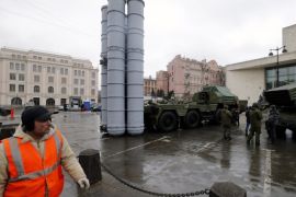 Visitors look at a Russian anti-aircraft missile system 'S-300PMU' (L) and multiple launch rocket system 'Grad' (R) during a military exhibition marking the Fatherland Defender Day in central St. Petersburg, Russia, 20 February 2015.