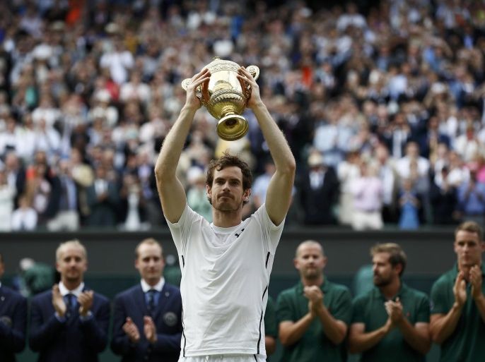 Britain Tennis - Wimbledon - All England Lawn Tennis & Croquet Club, Wimbledon, England - 10/7/16 Great Britain's Andy Murray celebrates winning the mens singles final against Canada's Milos Raonic with the trophy REUTERS/Stefan Wermuth
