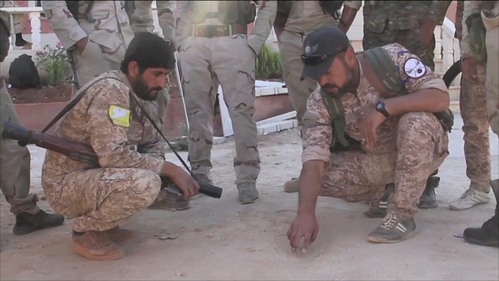 عناصر من قوات سوريا الديمقراطية تتفقد آثار قصف سابق لتنظيم الدولة في منبج (الجزيرة)