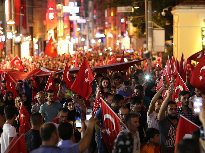 epa05428439 Supporters of Turkish President Recep Tayyip Erdogan shout slogans and hold flags during a demonstration, against the failed Army coup attempt, at Taksim Sqaure, in Istanbul, Turkey, 16 July 2016. Turkish Prime Minister Yildirim reportedly said that the Turkish military was involved in an attempted coup d'etat. The Turkish military meanwhile stated it had taken over control. According to news reports, Turkish President Recep Tayyip Erdogan has denounced the coup attempt as an 'act of treason' and insisted his government remains in charge. Some 104 coup plotters were killed, 90 people - 41 of them police and 47 are civilians - 'fell martrys', after an attempt to bring down the Turkish government, the acting army chief General Umit Dundar said in a televised appearance. EPA/TOLGA BOZOGLU