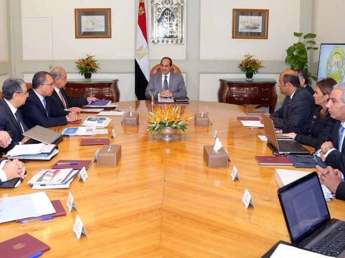 Egyptian President Abdel Fattah al-Sisi (C) attends a meeting with Egypt's Prime Minister Sherif Ismail and members of the government's Economic Ministerial Committee to discuss future economic indicators and figures of the general budget and the results of the talks with the International Monetary Fund (IMF) at the Ittihadiya presidential palace in Cairo, Egypt July 27, 2016 in this handout picture courtesy of the Egyptian Presidency. The Egyptian Presidency/Handout via REUTERS ATTENTION EDITORS - THIS IMAGE WAS PROVIDED BY A THIRD PARTY. EDITORIAL USE ONLY.