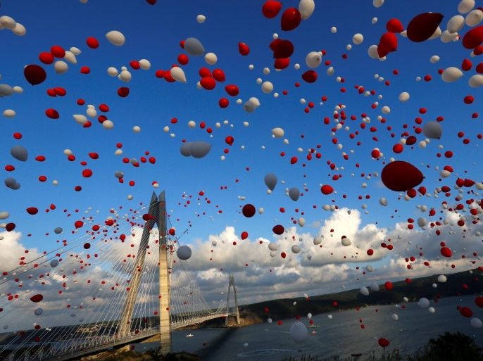 Red and white balloons are released during the opening ceremony of newly built Yavuz Sultan Selim bridge, the third bridge over the Bosphorus linking the city's European and Asian sides in Istanbul, Turkey, August 26, 2016. REUTERS/Murad Sezer