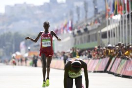 2016 Rio Olympics - Athletics - Final - Women's Marathon - Sambodromo - Rio de Janeiro, Brazil - 14/08/2016. First placed Jemima Sumgong (KEN) of Kenya reacts as second placed Eunice Jepkirui Kirwa (BRN) of Bahrain finishes. REUTERS/Dylan Martinez FOR EDITORIAL USE ONLY. NOT FOR SALE FOR MARKETING OR ADVERTISING CAMPAIGNS.