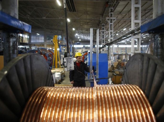 A worker checks copper cables being produced at a factory in the central Anatolian city of Kayseri February 12, 2015. President Tayyip Erdogan's tirades against the central bank may be stoking turmoil in Turkish financial markets, but they are winning praise from a class of industrialists who have thrived over the past decade and see him as a pillar of their success. Picture taken February 12, 2015. REUTERS/Umit Bektas (TURKEY - Tags: BUSINESS POLITICS)