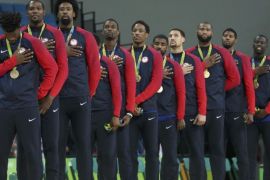 2016 Rio Olympics - Basketball - Final - Men's Gold Medal Game Serbia v USA - Carioca Arena 1 - Rio de Janeiro, Brazil - 21/8/2016. United States players stand with their gold medals for the playing of the U.S. National Anthem during the presentation ceremony for men's basketball. REUTERS/Shannon Stapleton FOR EDITORIAL USE ONLY. NOT FOR SALE FOR MARKETING OR ADVERTISING CAMPAIGNS.