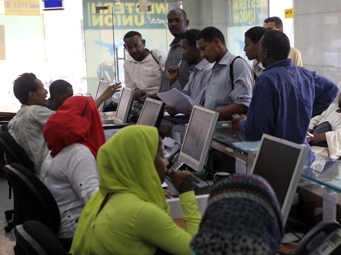 People wait in a queue to transfer money to their families and accounts abroad, at a licensed exchange bureaux in Khartoum May 29, 2012. Sudan's pound is under renewed pressure on the black market, with licensed exchange bureaux struggling to meet demand for dollars ahead of the summer travel season, dealers said. Picture taken May 29, 2012. REUTERS/ Mohamed Nureldin Abdallah (SUDAN - Tags: BUSINESS POLITICS)