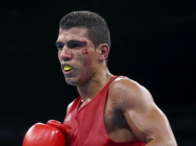 2016 Rio Olympics - Boxing - Semifinal - Men's Welter (69kg) Semifinals Bout 208 - Riocentro - Pavilion 6 - Rio de Janeiro, Brazil - 15/08/2016. Blood is seen on the face of Mohammed Rabii (MAR) of Morocco as he competes. REUTERS/Yves Herman FOR EDITORIAL USE ONLY. NOT FOR SALE FOR MARKETING OR ADVERTISING CAMPAIGNS.