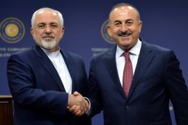 Iranian Foreign Minister Mohammad Javad Zarif (L) shakes hands with his Turkish counterpart Mevlut Cavusoglu after a news conference in Ankara, Turkey, August 12, 2016. REUTERS/Stringer FOR EDITORIAL USE ONLY. NO RESALES. NO ARCHIVES.