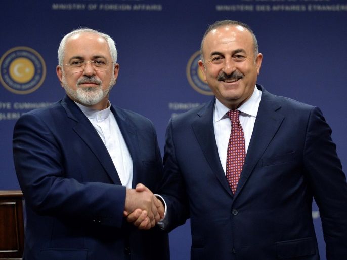 Iranian Foreign Minister Mohammad Javad Zarif (L) shakes hands with his Turkish counterpart Mevlut Cavusoglu after a news conference in Ankara, Turkey, August 12, 2016. REUTERS/Stringer FOR EDITORIAL USE ONLY. NO RESALES. NO ARCHIVES.