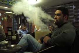 A man smokes shisha at a cafe in Baghdad December 17, 2014. Picture taken December 17, 2014. REUTERS/ Thaier Al-Sudani (IRAQ - Tags: SOCIETY)