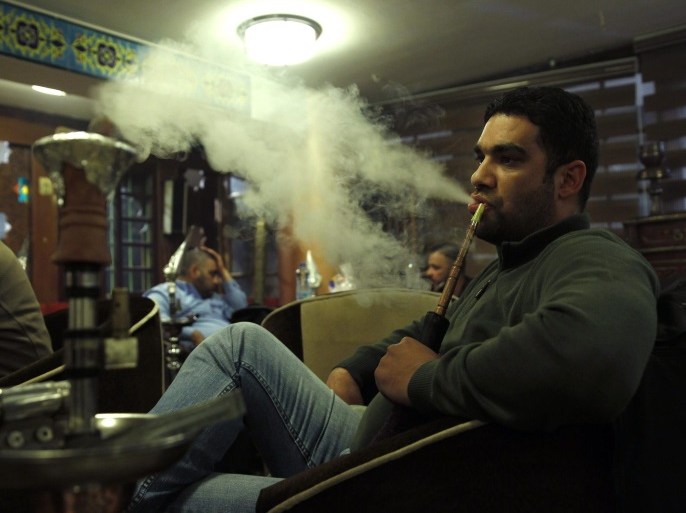 A man smokes shisha at a cafe in Baghdad December 17, 2014. Picture taken December 17, 2014. REUTERS/ Thaier Al-Sudani (IRAQ - Tags: SOCIETY)