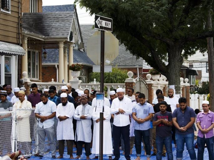 Community members pray outside the Al-Furqan Jame Masjid mosque before a funeral prayer for Imam Maulana Alauddin Akonjee and Thara Miah, who were shot and killed after prayers outside the mosque on 14 August, in Queens, New York, New York, USA, 15 August 2016. US media reports state that the New York City Police Department has a suspect in custody. The man has not yet been charged or identified.