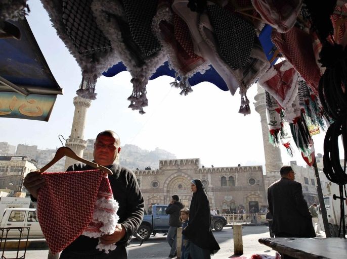 A vendor displays the traditional Arabian headdress at his shop near the Grand Husseini Mosque in downtown Amman in this January 21, 2014 file photo. A growing sense that regional upheaval has brought more pain than progress has combined with international aid, some political reform, state control and co-opting of opponents to sap opposition to the pro-Western monarch's 15-year-old rule. REUTERS/Muhammmad Hamed/Files (JORDAN - Tags: BUSINESS POLITICS)