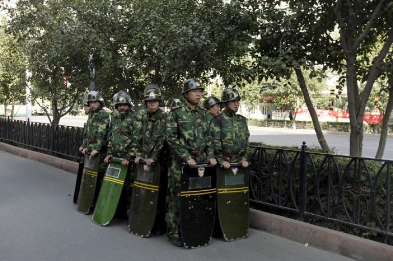 Chinese security forces stand in formation as they secure a street in Urumqi in China's Xinjiang Autonomous Region in this September 6, 2009 file photo. To match Special Report CHINA-UIGHURS/ REUTERS/Nir Elias/Files