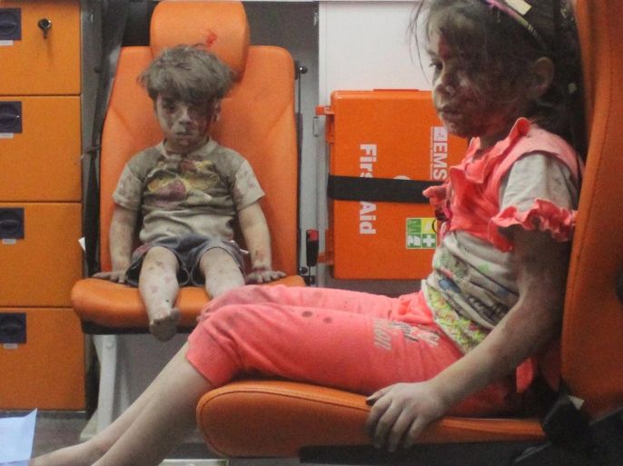 Five-year-old Omran Daqneesh, with bloodied face, sits with his sister inside an ambulance after they were rescued following an airstrike in the rebel-held al-Qaterji neighbourhood of Aleppo, Syria August 17, 2016. Picture taken August 17, 2016. REUTERS/Mahmoud Rslan EDITORIAL USE ONLY. NO RESALES. NO ARCHIVES TPX IMAGES OF THE DAY