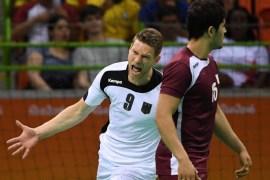 Germany's Tobias Reichmann (L) and Qatar's Nasreddine Megdich react after a goal during the men's quarterfinal Handball match between Germany and Qatar of the Rio 2016 Olympic Game at Future Arena in the Olympic Park, Rio de Janeiro, Brazil, 17 August 2016.