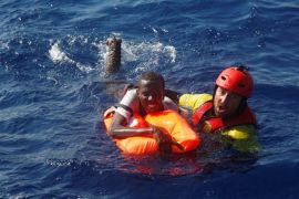 A member of the Spanish NGO Proactiva rescues a Somali migrant that fell from an overcrowded dinghy, during a rescue operation off the Libyan coast in Mediterranean Sea August 28 , 2016. REUTERS/Giorgos Moutafis