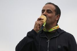 2016 Rio Olympics - Shooting - Victory Ceremony - Men's Double Trap Victory Ceremony - Olympic Shooting Centre - Rio de Janeiro, Brazil - 10/08/2016. Fehaid Aldeehani (KUW) of Independent Olympic Athlete kisses his gold medal. REUTERS/Edgard Garrido FOR EDITORIAL USE ONLY. NOT FOR SALE FOR MARKETING OR ADVERTISING CAMPAIGNS.