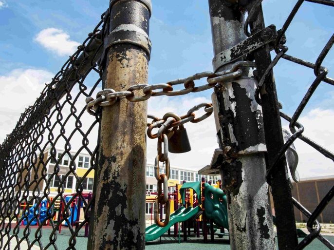 A playground is seen behind a locked gate at Woods Elementary Math & Science Academy in Chicago, Illinois, United States, in this file photo from May 8, 2015. The Chicago Board of Education's $875 million bond issue next week comes as the nation's third-largest public school system struggles with a structural budget deficit of at least $1 billion. Rated below investment-grade, the Chicago Board of Education is likely to attract a new class of investors not typical to the municipal bond market. REUTERS/Jim Young/Files