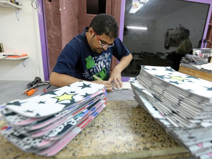 A man works at "Okhtein" workshop, a local brand Co-founded by sisters Aya and Mounaz Abdelraouf, in Cairo, Egypt May 26, 2016. REUTERS/Mohamed Abd El Ghany