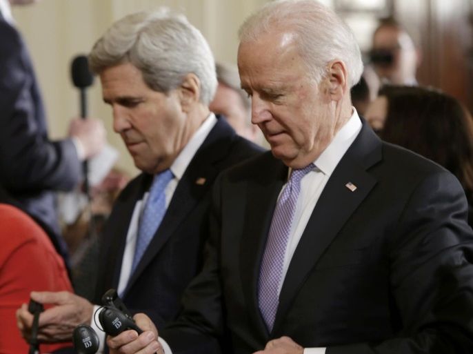 U.S. Secretary of State John Kerry and Vice President Joe Biden check their headsets prior to U. S. President Barack Obama and German Chancellor Angela Merkel address a joint news conference in the East Room of the White House in Washington February 9, 2015. REUTERS/Gary Cameron (UNITED STATES - Tags: POLITICS CIVIL UNREST)