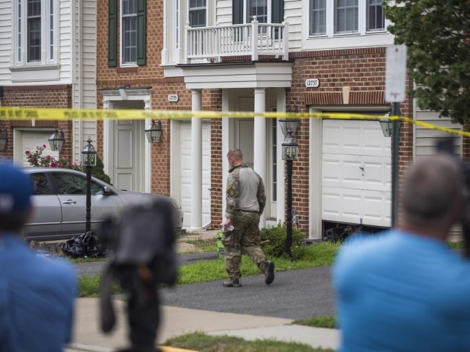 Law enforcement officers stand outside the home of DC Metro Transit police officer Nicholas Young, who the FBI arrested and charged with providing assistance to the so-called Islamic State (IS) earlier in the day, in Fairfax, Virginia, USA, 03 August 2016. Young was under surveillance for six years.