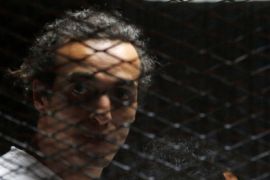 Egyptian photojournalist Mahmoud Abu Zeid, also known as "Shawkan", looks on behind bars in his trial at on the outskirts of Cairo, Egypt May 31, 2016. REUTERS/Amr Abdallah Dalsh