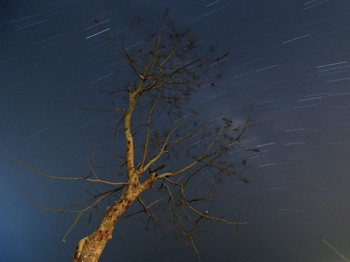 A long exposure photograph shows stars and meteors illuminating the dark sky during the Lyrid meteor shower in Yangon, Myanmar, early 23 April 2015. The Lyrid meteor shower occurs every year between 16 April to 26 April.