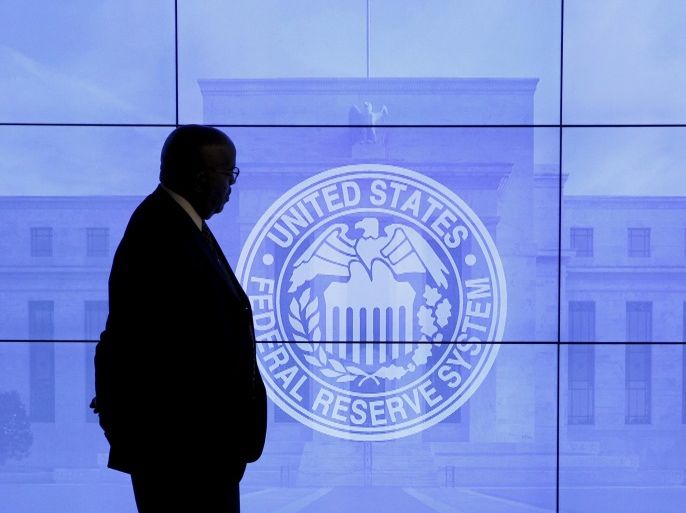 A security guard walks in front of an image of the Federal Reserve following the two-day Federal Open Market Committee (FOMC) policy meeting in Washington, DC, U.S. on March 16, 2016. REUTERS/Kevin Lamarque/File Photo