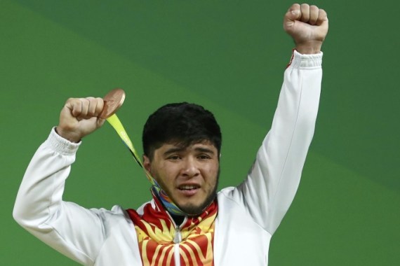 2016 Rio Olympics - Weightlifting - Men's 69kg Victory Ceremony - Riocentro - Pavilion 2 - Rio de Janeiro, Brazil - 09/08/2016. Izzat Artykov (KGZ) of Kyrgyzstan poses with his medal. REUTERS/Yves Herman FOR EDITORIAL USE ONLY. NOT FOR SALE FOR MARKETING OR ADVERTISING CAMPAIGNS.