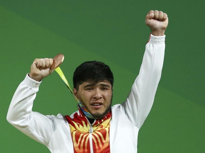 2016 Rio Olympics - Weightlifting - Men's 69kg Victory Ceremony - Riocentro - Pavilion 2 - Rio de Janeiro, Brazil - 09/08/2016. Izzat Artykov (KGZ) of Kyrgyzstan poses with his medal. REUTERS/Yves Herman FOR EDITORIAL USE ONLY. NOT FOR SALE FOR MARKETING OR ADVERTISING CAMPAIGNS.